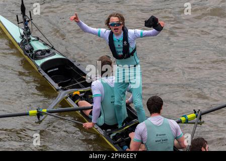 Chiswick Bridge, Chiswick, London, UK. 26th Mar, 2023. The rowers of Cambridge celebrating their victory over the Oxford team in the 168th Men’s Boat Race on the River Thames after the finish line at Mortlake before Chiswick Bridge. Cox Jasper Parish Stock Photo