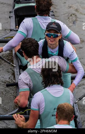 Cambridge men's cox Jasper Parish (centre) celebrates with the trophy ...