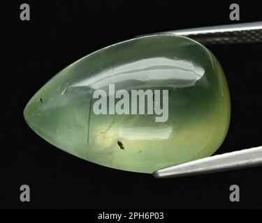 Natural gem green prehnite on gray background Stock Photo