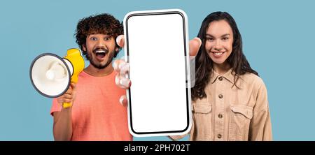 Online Offer. Indian Man Using Megaphone While Young Woman Holding Blank Smartphone Stock Photo
