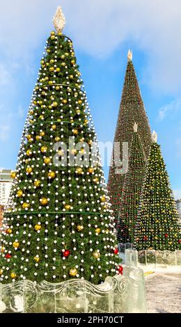 Big decorated Christmas trees with balls against at the city street. New Year's celebration Stock Photo