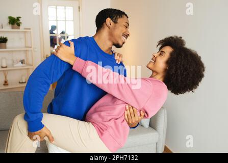 Cheerful African American Couple Dancing And Having Fun At Home Stock Photo