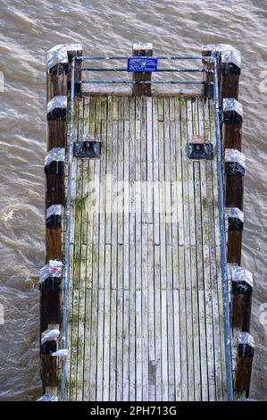 Enjoy a captivating aerial view of a jetty on the River Thames from above. Experience the charm and beauty of London's waterfront. Stock Photo