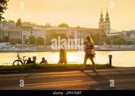 Woman taking a selfie on the go at sunset Stock Photo