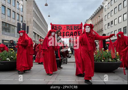 Red rebel brigade perform a silent climate protest at Nørreport station Copenhagen, Denmark, Mars 25, 2023 Stock Photo