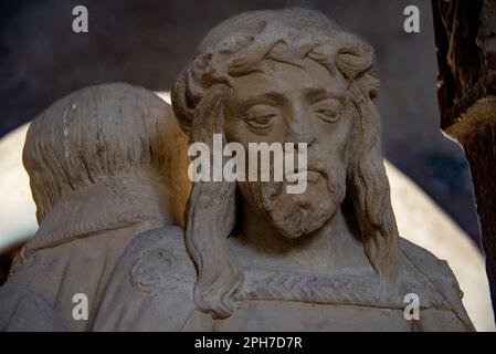 Figures of a medieval crucifixion group carved from stone on display at the museum in Carcassonne castle. Stock Photo