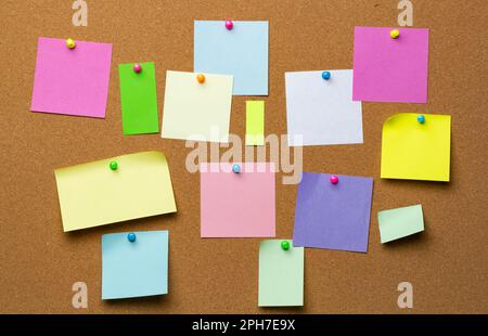 Post blank stickers on cork bulletin board. Concept of business notes. Stock Photo