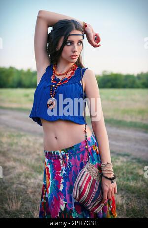 Outdoor portrait of the attractive young boho (hippie) girl in field Stock Photo