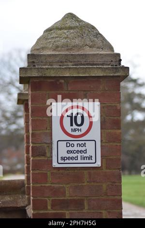 Road sign on a brick wall in Milton Keynes: '10 MPH do not exceed speed limit'. Stock Photo
