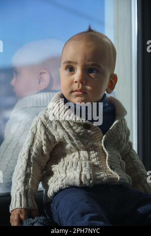 Boy In Cozy Beige Clothes Applying Sunscreen Protection Creme On