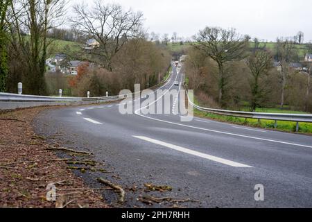 Road with white markings and a turn in the countryside in spring or autumn. Stock Photo