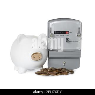 Electricity meter, piggy bank and coins on white background Stock Photo