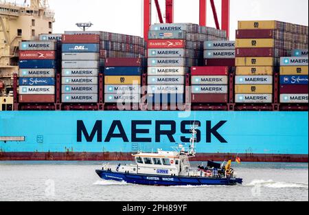 Wilhelmshaven, Germany. 20th Mar, 2023. A boat of the Lower Saxony water police sails along in front of the container ship 'Morten Maersk' of the Danish shipping company Maersk Line, which is moored at a quay wall at the container terminal JadeWeserPort. The Lower Saxony Ministry of Economics, the Lower Saxony Port Authority and the companies Seaports of Niedersachsen, Niedersachsen Ports and JadeWeserPort Realisierungs GmbH & Co. KG will report on the current situation of Lower Saxony's seaports at a press conference. Credit: Hauke-Christian Dittrich/dpa/Alamy Live News Stock Photo