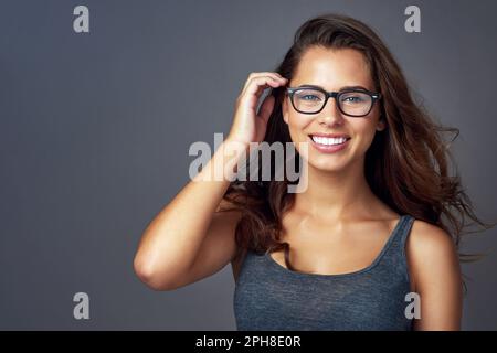 What a nice surprise. Studio shot of beautiful young woman posing against a coloured background. Stock Photo