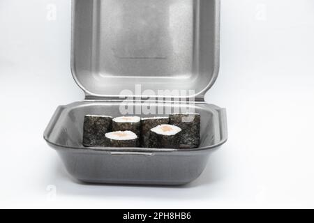 plastic food container with sushi from restaurant on isolated background, takeaway food order Stock Photo