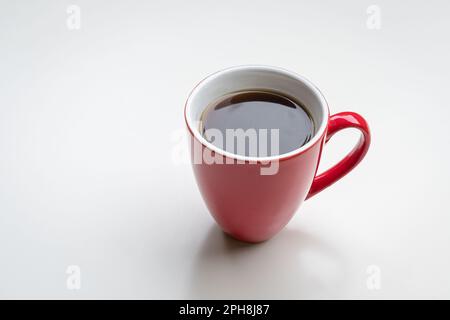 Coffee in red cup, isolated on white background. Copy space. Stock Photo