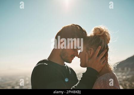 Your love makes me feel on top of the world. an affectionate couple on a mountain top. Stock Photo