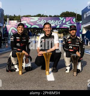Sao Paulo, Brazil. 25th Mar, 2023. STREETS OF SAO PAULO, BRAZIL - MARCH 25: Mitch Evans, Jaguar TCS Racing, 1st position, James Barclay, Team Director, Jaguar TCS Racing, and Sam Bird, Jaguar TCS Racing, 3rd position, with the trophies during the Sao Paulo ePrix at Streets of Sao Paulo on Saturday March 25, 2023, Brazil. (Photo by Andrew Ferraro/LAT Images) (Andrew Ferraro/ATP/SPP) Credit: SPP Sport Press Photo. /Alamy Live News Stock Photo