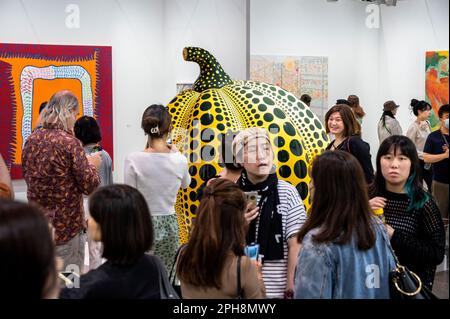 Hong Kong, China. 24th Mar, 2023. Visitors and collectors view the ''Pumpkin'' sculpture by Japanese artist Yayoi Kusama at the Art Basel Hong Kong show after several years of remote and hybrid events due to covid restrictions in Hong Kong. (Credit Image: © Sebastian Ng/SOPA Images via ZUMA Press Wire) EDITORIAL USAGE ONLY! Not for Commercial USAGE! Stock Photo