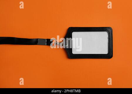 Blank badge on orange background, top view. Mockup for design Stock Photo