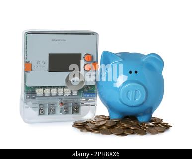 Electricity meter, piggy bank and coins on white background Stock Photo