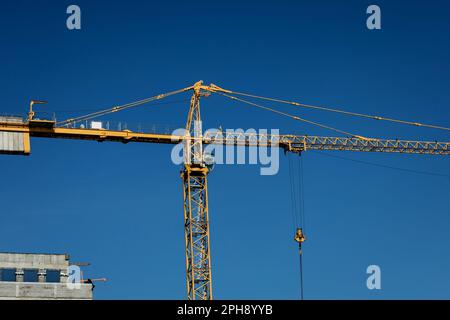 construction tower crane against blue sky. industrial concept Stock Photo