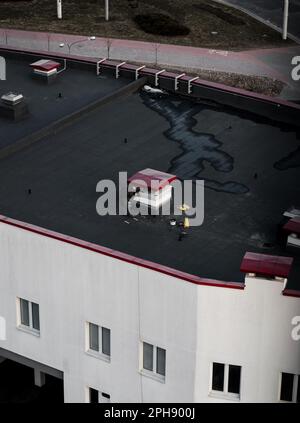 Construction worker plasterer with wall plastering tools renovating building. Plasterer renovating roof mall Stock Photo