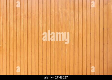 Light honey-colored glazed wooden wall made of vertical boards Stock Photo