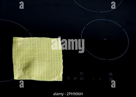 rag on an electric stove. kitchen cleaning and induction Stock Photo