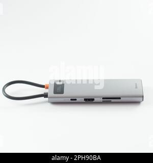 Ivano-Frankivsk, Ukraine, January 28, 2023: Baseus USB adapter with different inputs for flash drive, hdmi, ethernet, memory card, cables on white bac Stock Photo