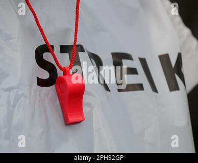 Dresden, Germany. 27th Mar, 2023. An employee of the Dresdner Verkehrsbetriebe (DVB) wears a whistle around his neck during the warning strike at the Trachenberge depot. With a large-scale nationwide warning strike, the unions EVG and Verdi paralyzed large parts of public transport on Monday. Credit: Robert Michael/dpa/Alamy Live News Stock Photo