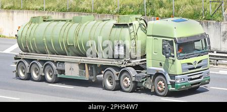 Non Hazardous Product transported in unmarked olive green articulated tanker trailer & historical Foden hgv  lorry truck driving M25 UK motorway road Stock Photo