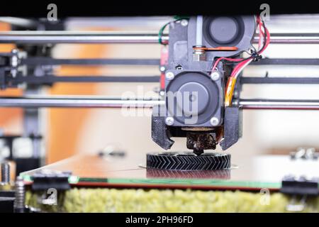 3d printer printing objects closeup. Modern technical 3D printing. Stock Photo