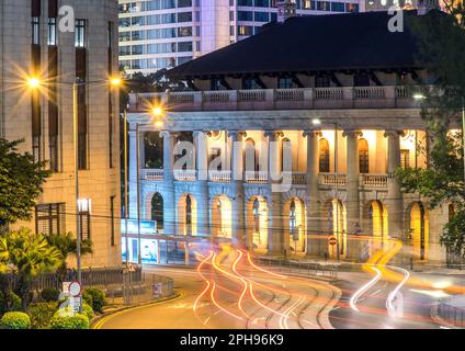 Bus lights in front of the Former Legco building at dusk, Hong Kong Stock Photo