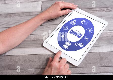 Driverless car concept shown on a tablet used by a woman Stock Photo