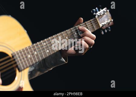 A man plays an acoustic guitar, close-up. Stock Photo