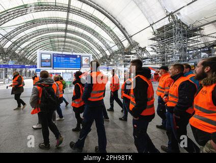 Dresden, Germany. 27th Mar, 2023. Participants of the warning strike walk through the main train station. With a large-scale nationwide warning strike, the unions EVG and Verdi paralyzed large parts of the public transport system on Monday. Credit: Robert Michael/dpa/Alamy Live News Stock Photo