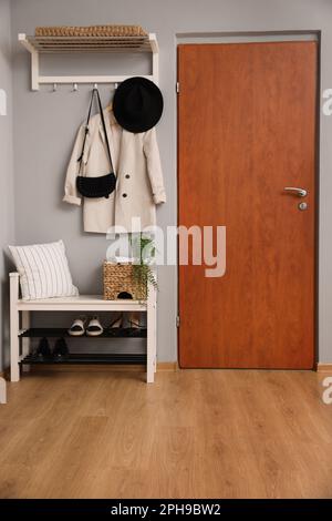 Modern hallway interior with stylish furniture near wooden door Stock Photo