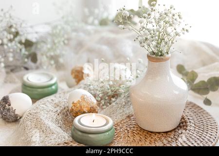 Easter composition with gypsophila flowers and Easter eggs. Stock Photo