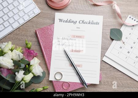 Flat lay composition with Wedding Checklist and planner on wooden table Stock Photo