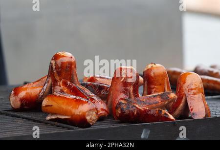 Grilling of sausages and kielbasa at the farmers street food market in Prague, no smoke, no people, no AI. Stock Photo