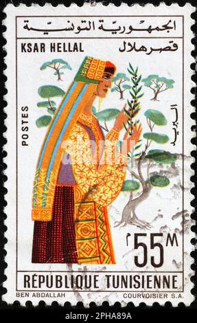 Traditionally dressed woman on tunisian postage stamp Stock Photo