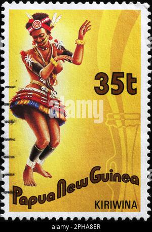 Woman dancing on postage stamp from Papua New Guinea Stock Photo