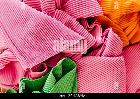 An image featuring an array of various-sized and colored fabrics Stock Photo