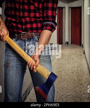 Murderer with a bloodstained ax in a corridor of an apartment building. Stock Photo