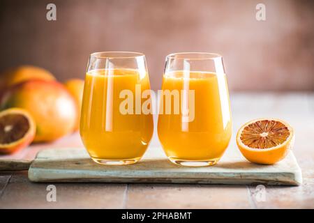 Two mango lassi or kesar milk in glasses. Indian healthy ayurvedic cold drink with mango. Freshness lassi made of yogurt, water, spices, fruits and ic Stock Photo