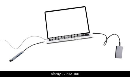 Laptop with cables and devices floating on white background. Stock Photo
