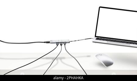 Laptop on white desk with floating mouse and cable. Connection concept. Stock Photo