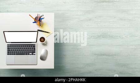 Laptop with white screen on office table. Top view with empty copy space. Stock Photo