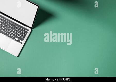 Laptop with blank screen on colored background, Top view with empty copy space. Stock Photo